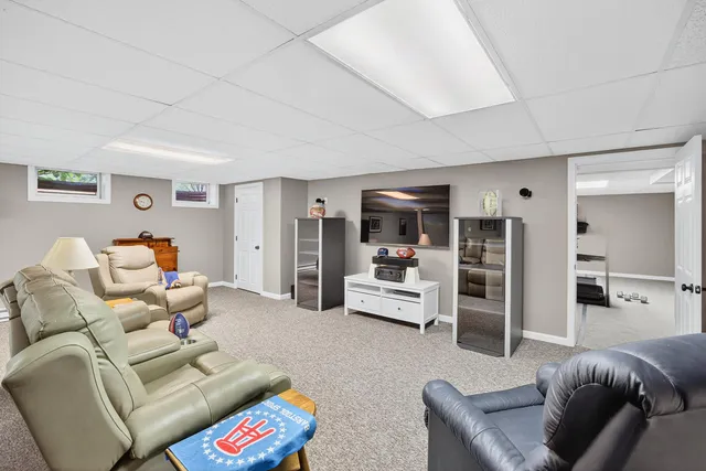 a view of a house with a yard potted plants and large tree