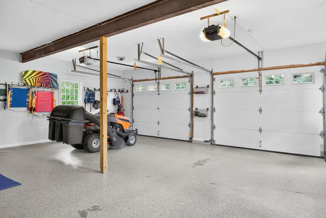 a view of a white vase with flowers on a counter