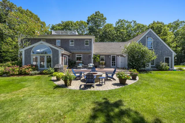 a front view of a house with a garden and patio