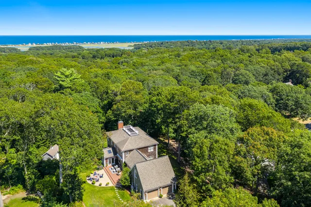 an aerial view of a house with a yard
