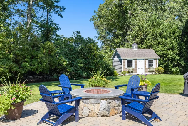 a view of a chairs and table in backyard of the house
