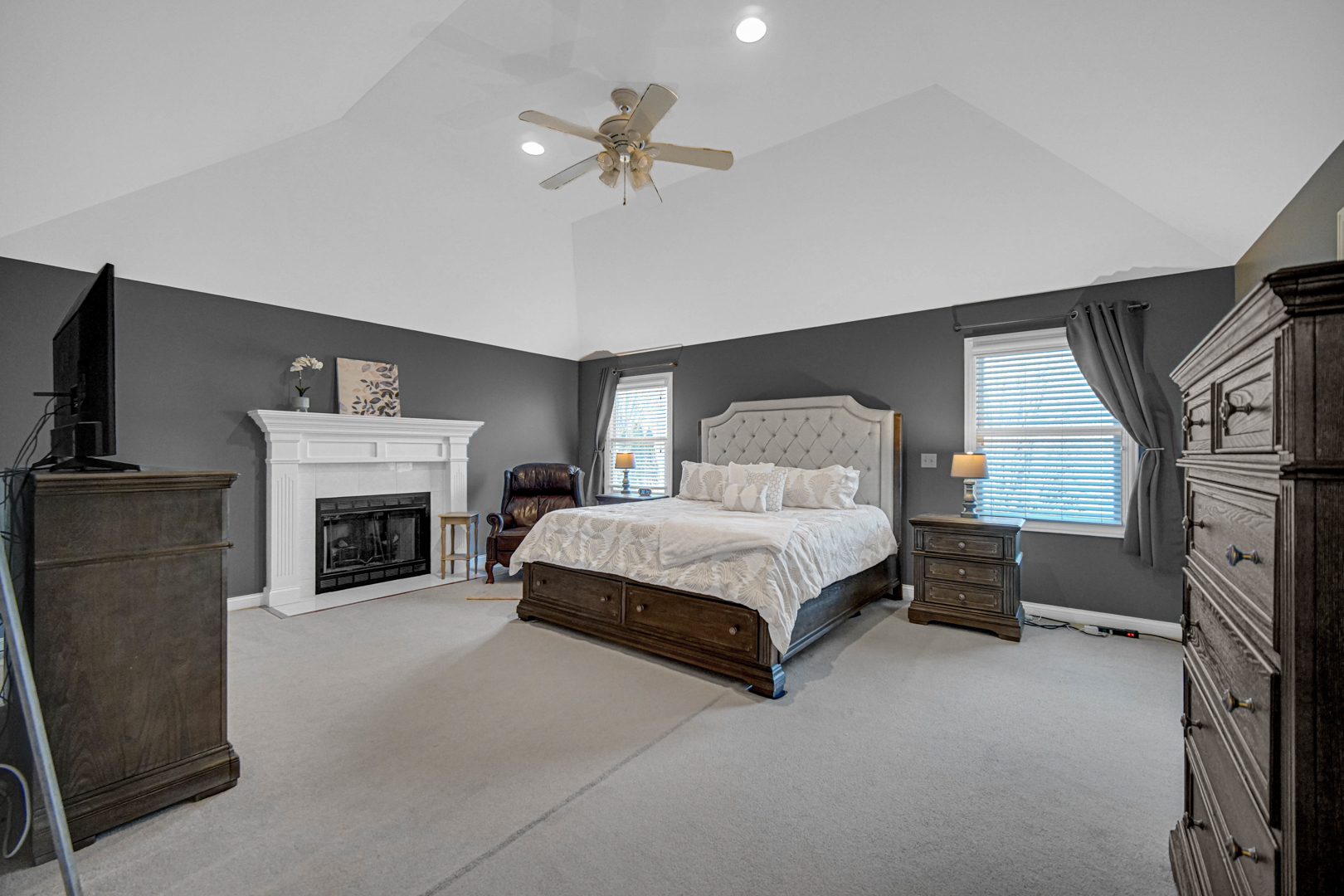 25216 Round Barn Road Plainfield, IL 60585 - Photo 18 of 31 a spacious bedroom with a bed and a fireplace