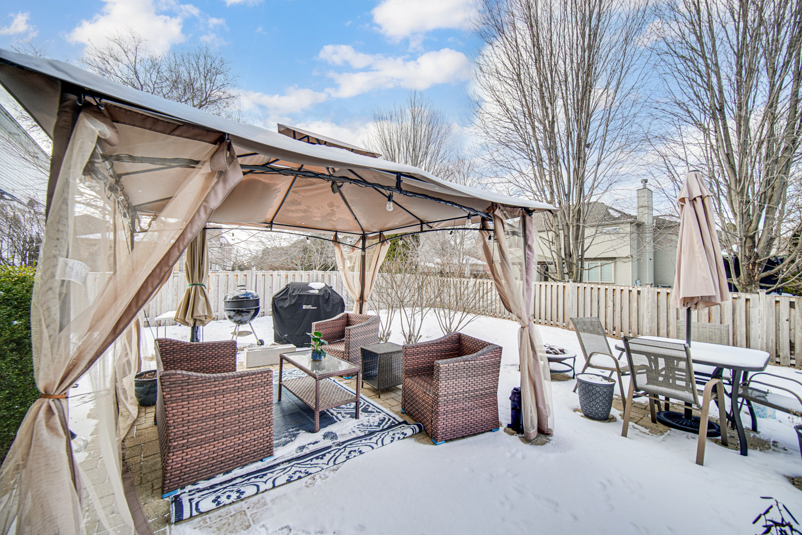 25216 Round Barn Road Plainfield, IL 60585 - Photo 29 of 31 a view of a patio with a table and chairs and couches