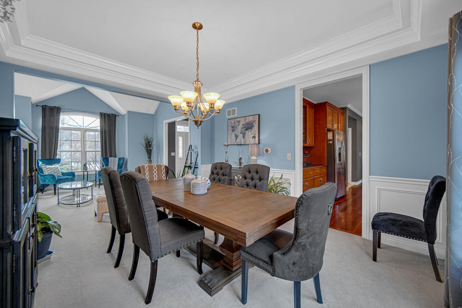 25216 Round Barn Road Plainfield, IL 60585 - Photo 8 of 31 a view of a dining room and livingroom with furniture wooden floor a chandelier