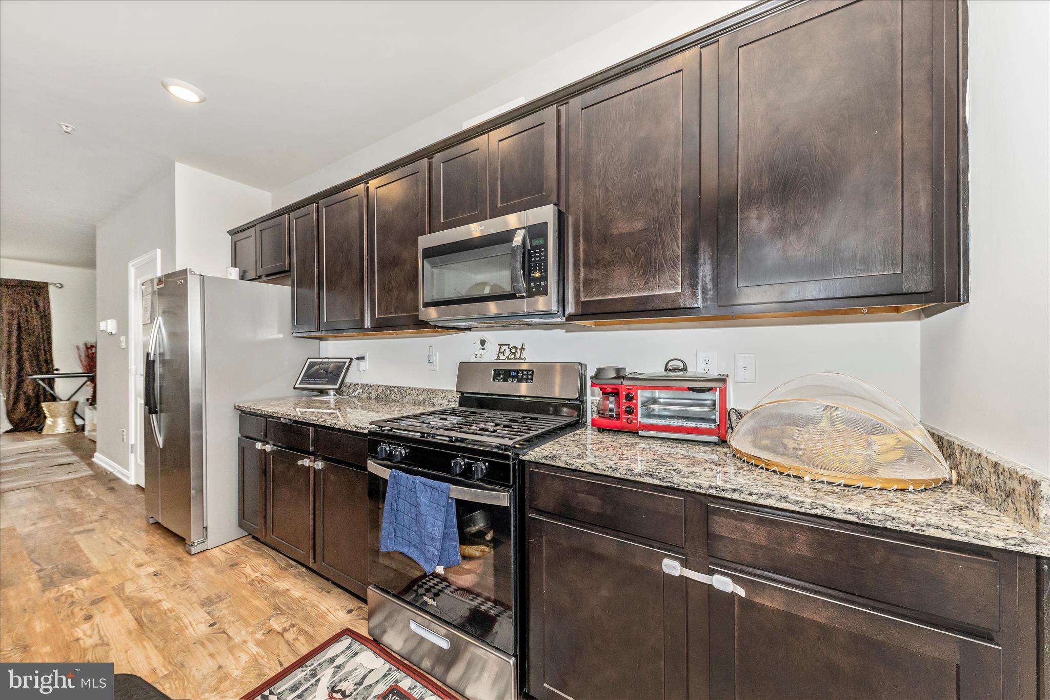 8648 Walter Martz Road Frederick, MD 21702 - Photo 13 of 50 a kitchen with stainless steel appliances granite countertop a stove a sink and a microwave