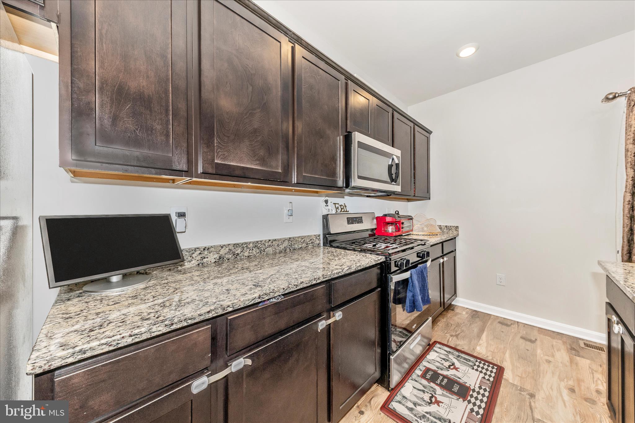 8648 Walter Martz Road Frederick, MD 21702 - Photo 14 of 50 a kitchen with stainless steel appliances granite countertop a sink stove and cabinets