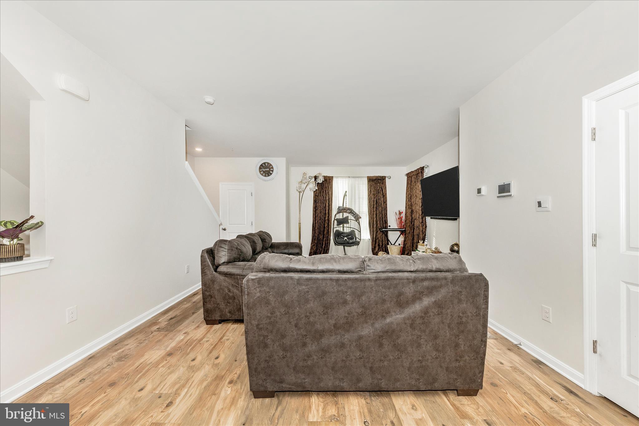 8648 Walter Martz Road Frederick, MD 21702 - Photo 17 of 50 a living room with furniture a flat screen tv and a wooden floor