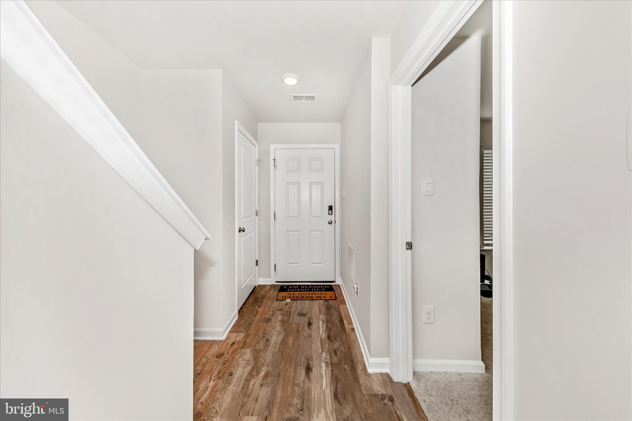 8648 Walter Martz Road Frederick, MD 21702 - Photo 2 of 50 a view of a hallway with wooden floor and staircase