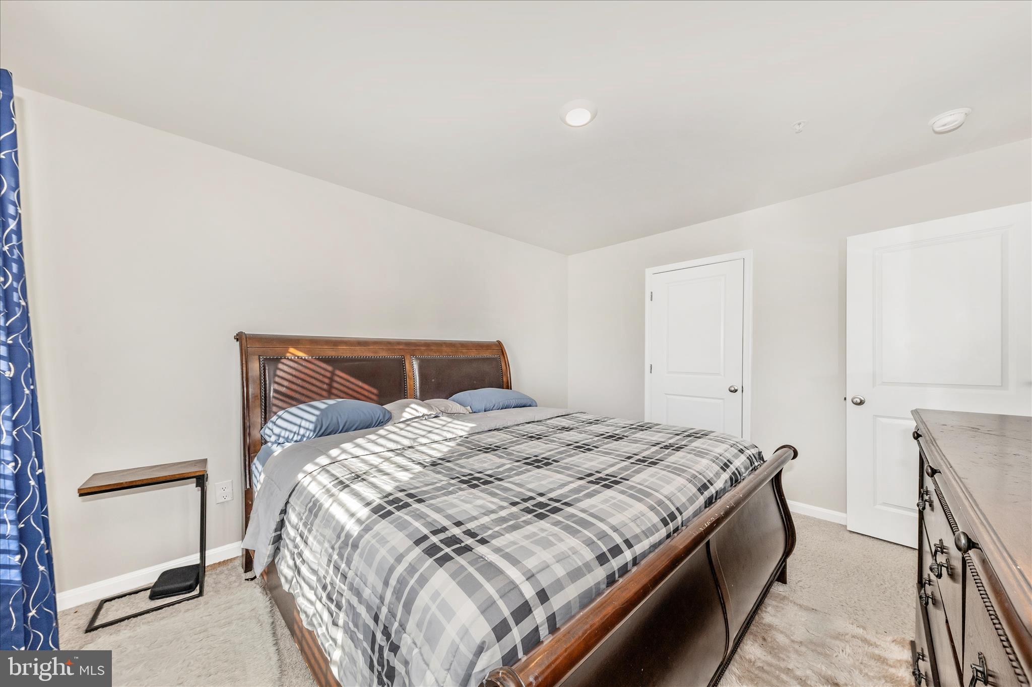 8648 Walter Martz Road Frederick, MD 21702 - Photo 25 of 50 a bedroom with a bed and a lamp