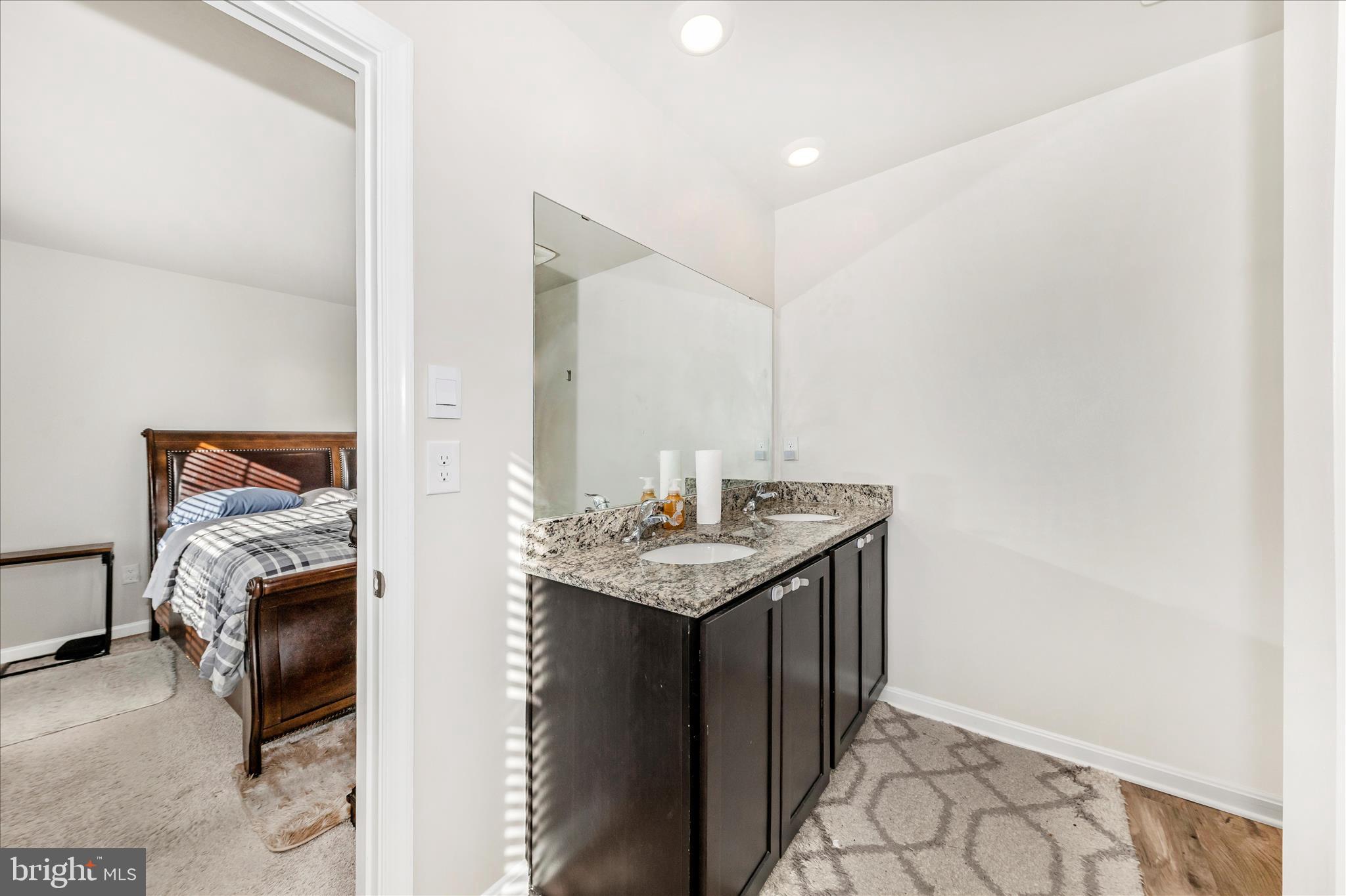 8648 Walter Martz Road Frederick, MD 21702 - Photo 28 of 50 a en suite bathroom with a granite countertop sink and a mirror