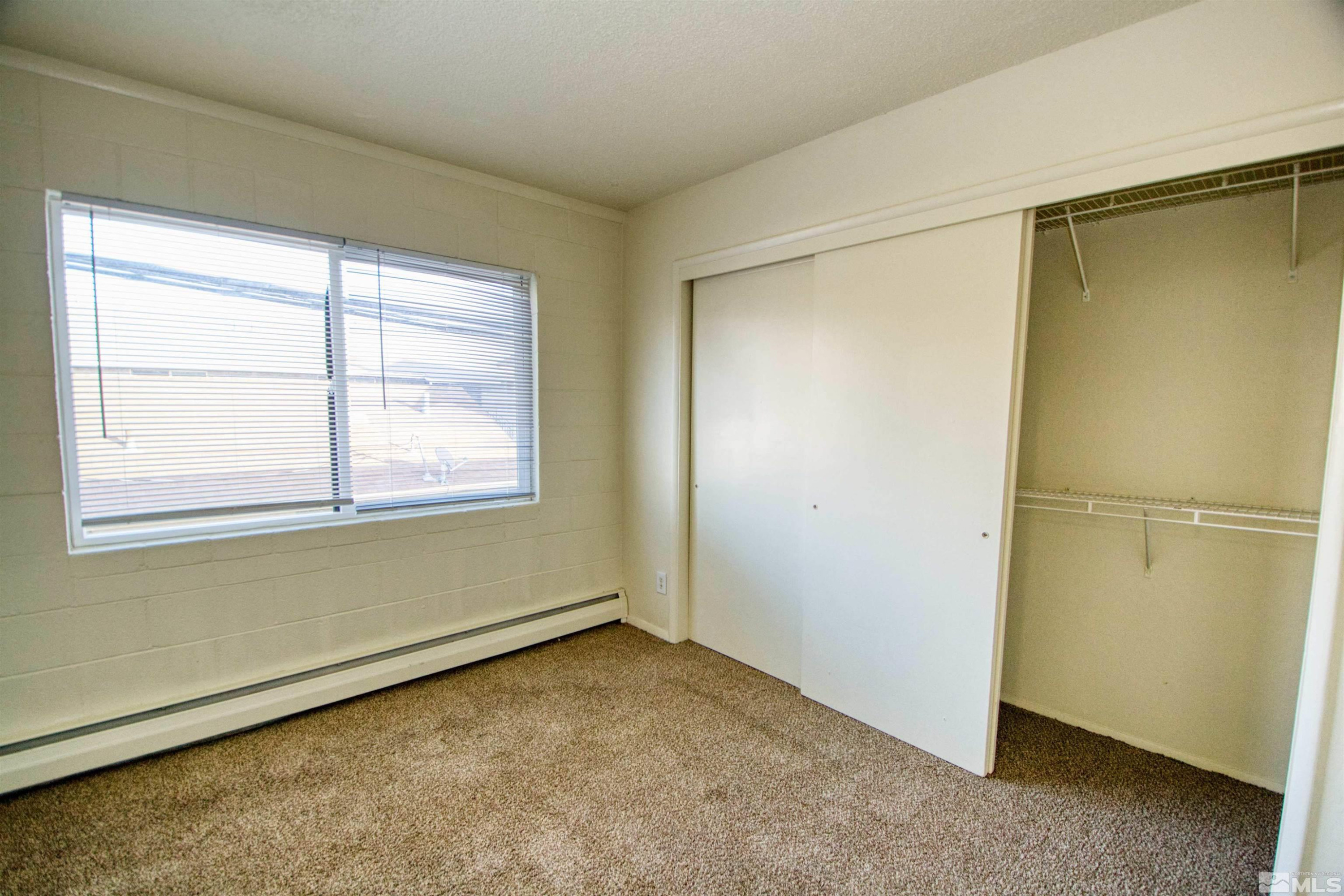 511 Country Village Drive, Unit 22 Carson City, NV 89701 - Photo 8 of 11 a view of an empty room with a window