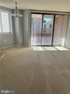 en empty room with windows and stairs