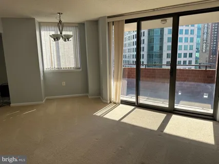 a view of an empty room with windows