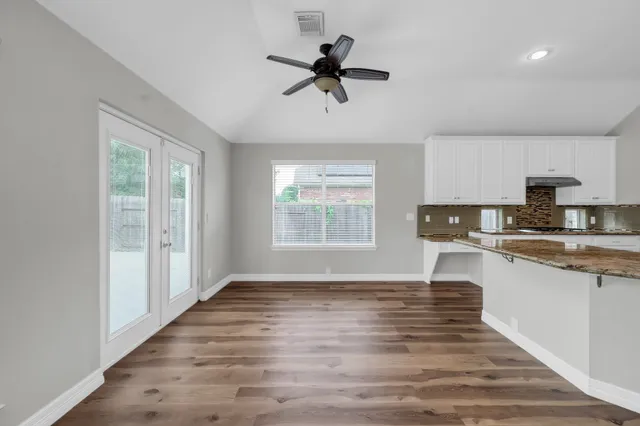 a spacious bathroom with a granite countertop tub a sink and a granite counter tops