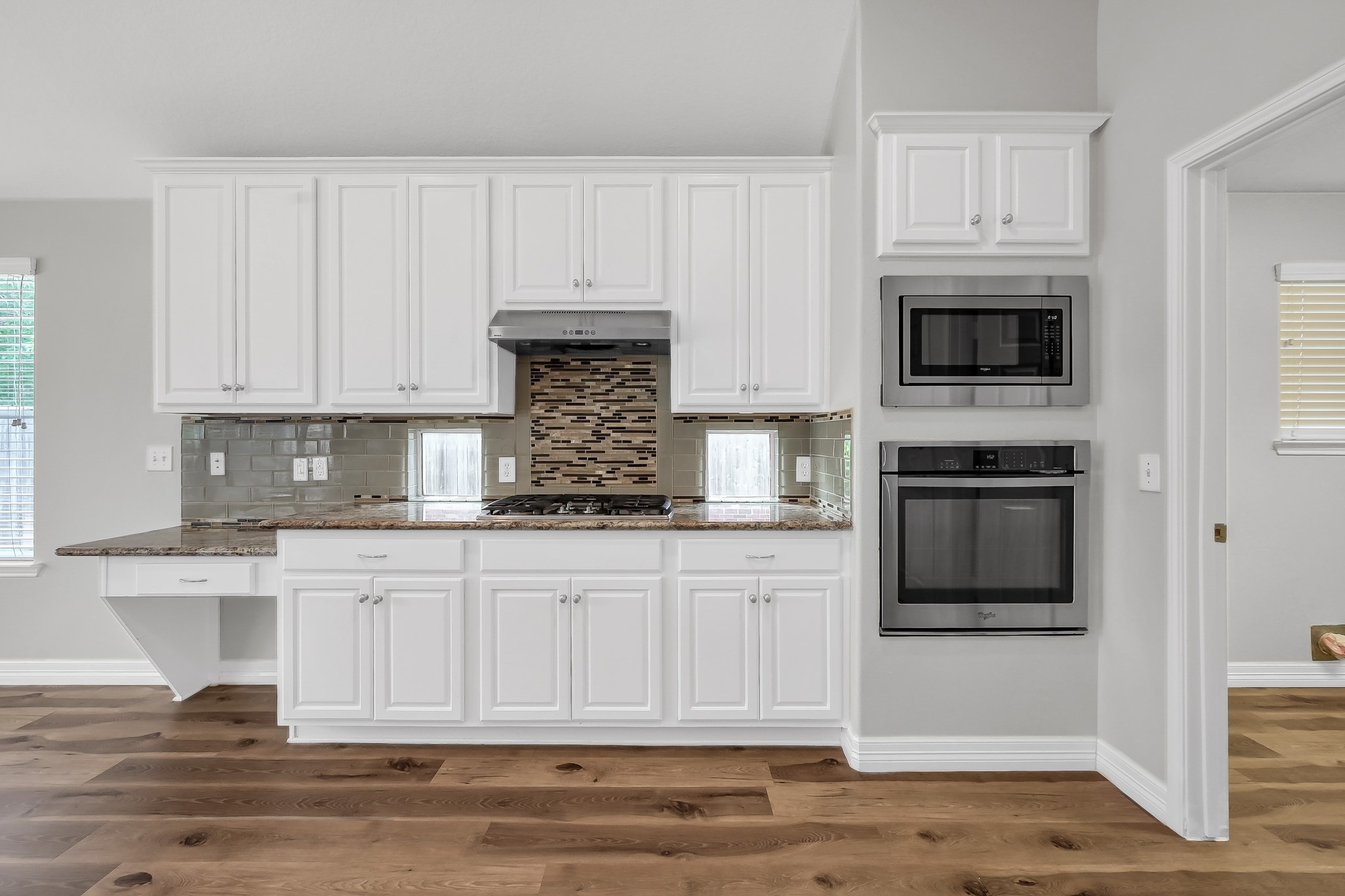 2906 Reynolds Creek Drive Spring, TX 77388 - Photo 19 of 38 a kitchen with white cabinets and appliances