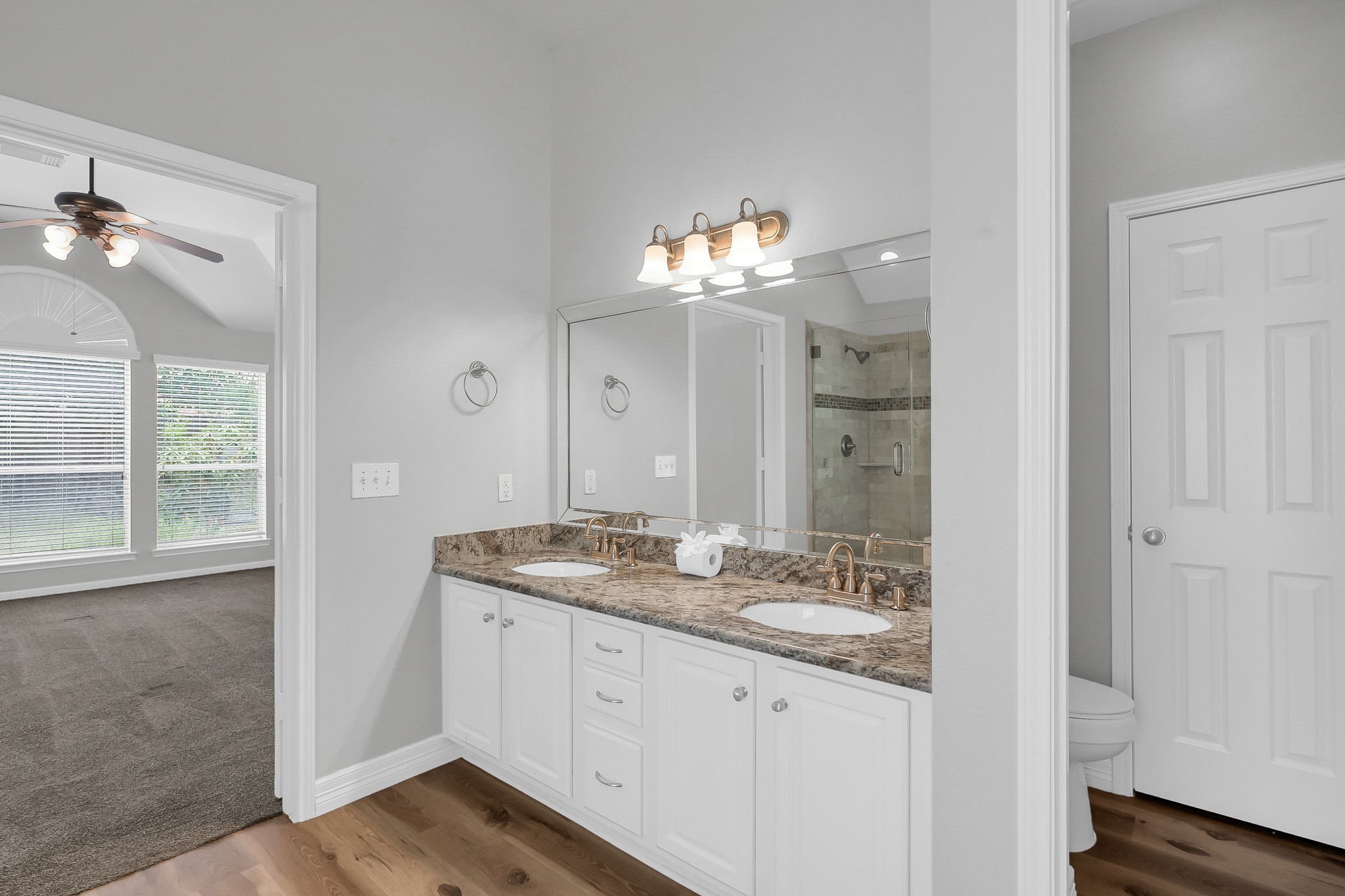 2906 Reynolds Creek Drive Spring, TX 77388 - Photo 23 of 38 a bathroom with a granite countertop sink a large mirror and a shower