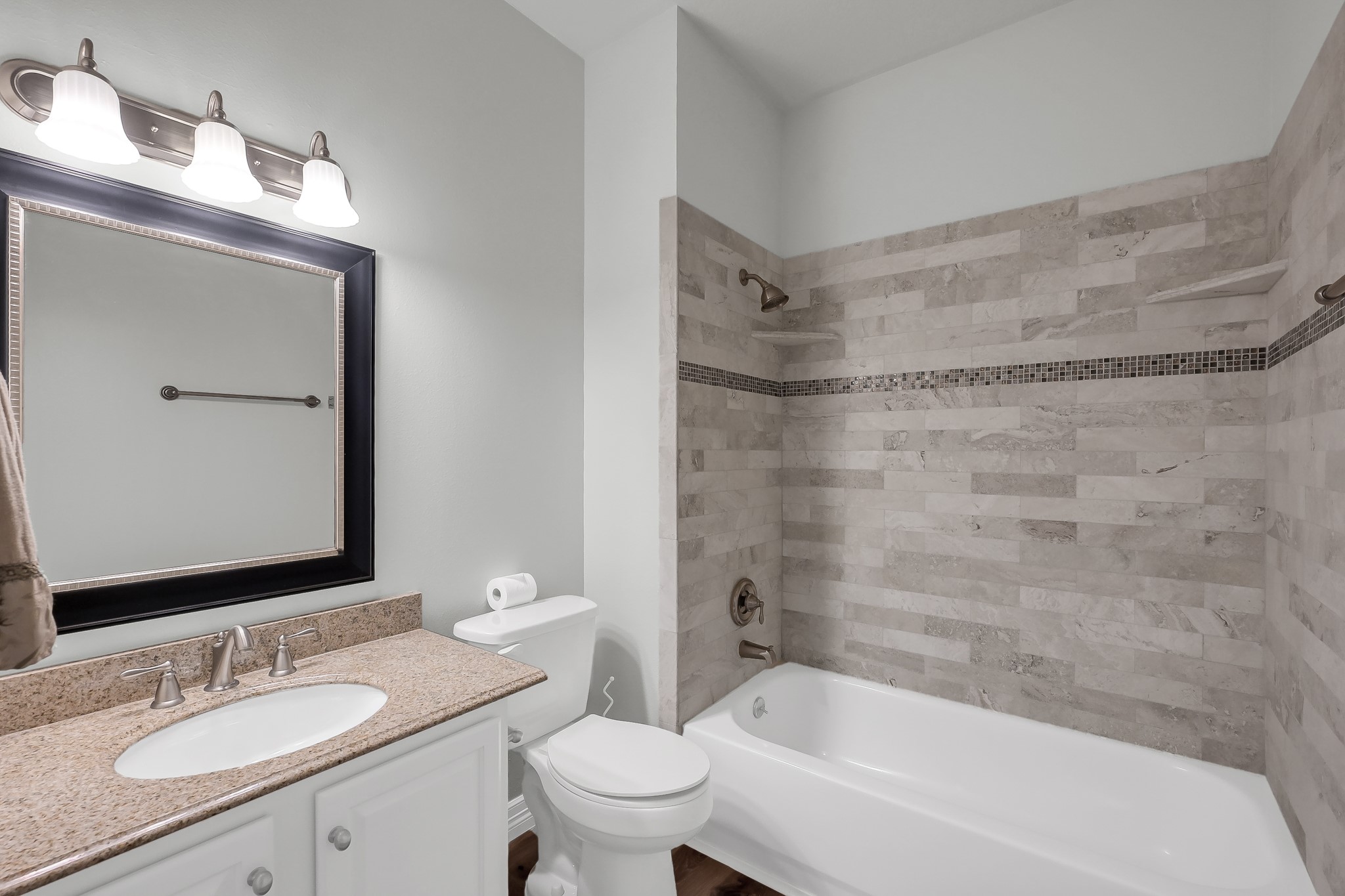 2906 Reynolds Creek Drive Spring, TX 77388 - Photo 29 of 38 a bathroom with a granite countertop bathtub shower sink mirror vanity and toilet