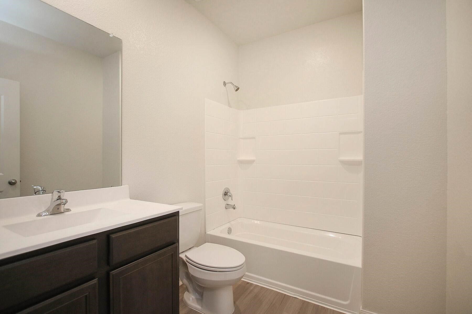22422 Kennons Way Hockley, TX 77447 - Photo 7 of 11 a bathroom with a sink a toilet and shower