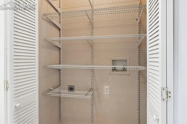 a close view of a utility room with racks on the wall