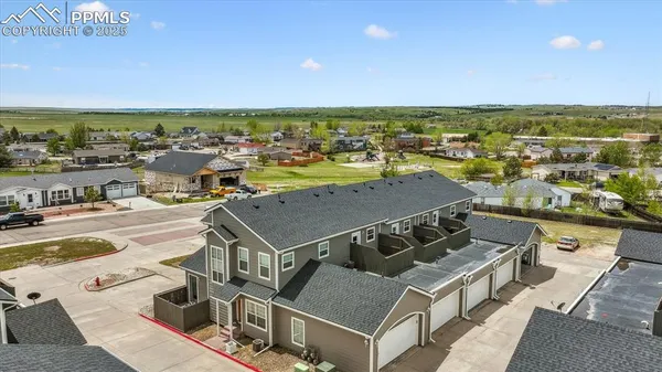 an aerial view of a house with outdoor space