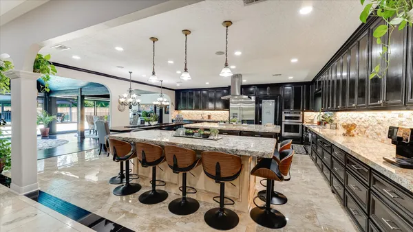 a kitchen with sink stove and cabinets