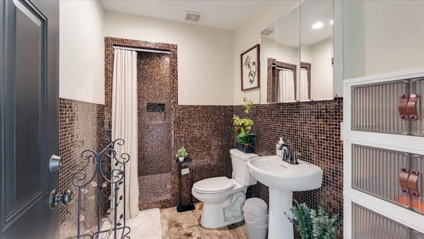 a room with furniture a rug and white walls