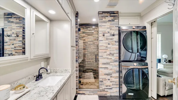 a white toilet sitting next to a bathroom sink
