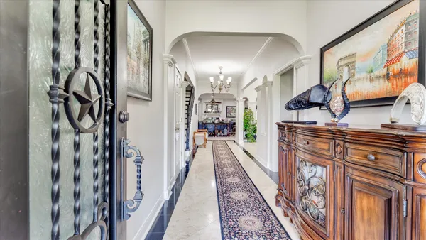 a living room with furniture and a chandelier