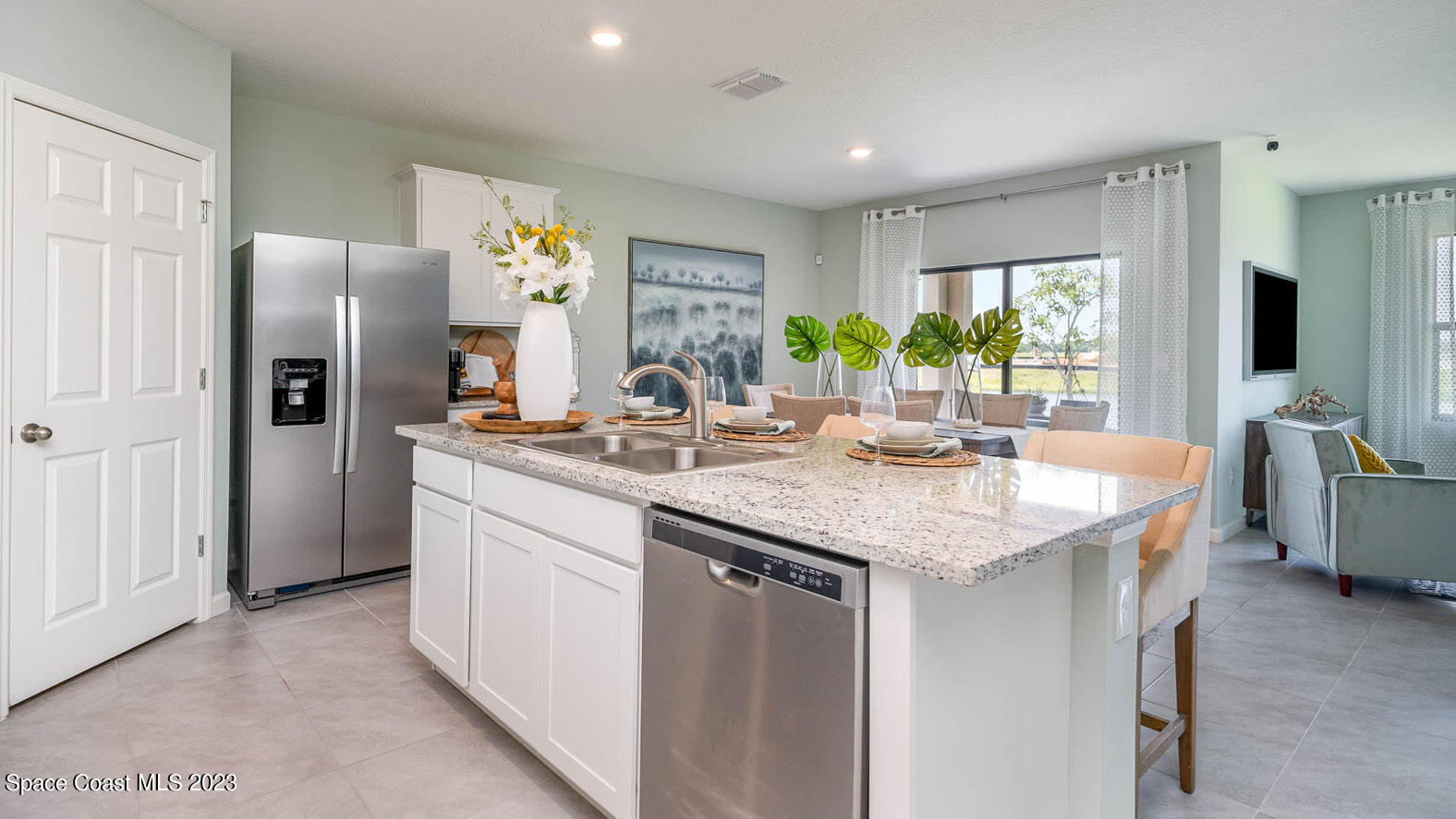 4954 Quartz Place Grant-Valkaria, FL 32949 - Photo 4 of 48 a kitchen with stainless steel appliances granite countertop a sink and refrigerator