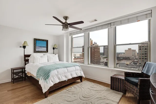 a bedroom with a bed and a large window