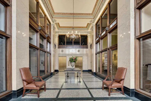 a living room with furniture and a lamp