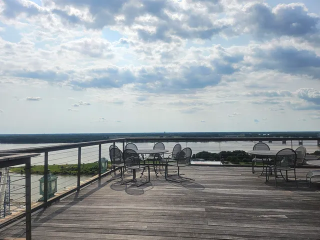 a roof deck with a table and chairs
