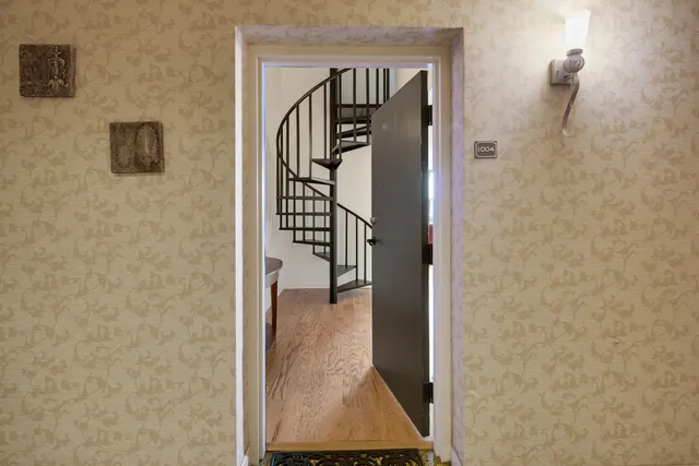 a view of entryway with wooden floor and stairs