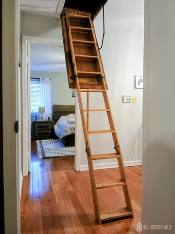 a view of entryway and hall with wooden floor