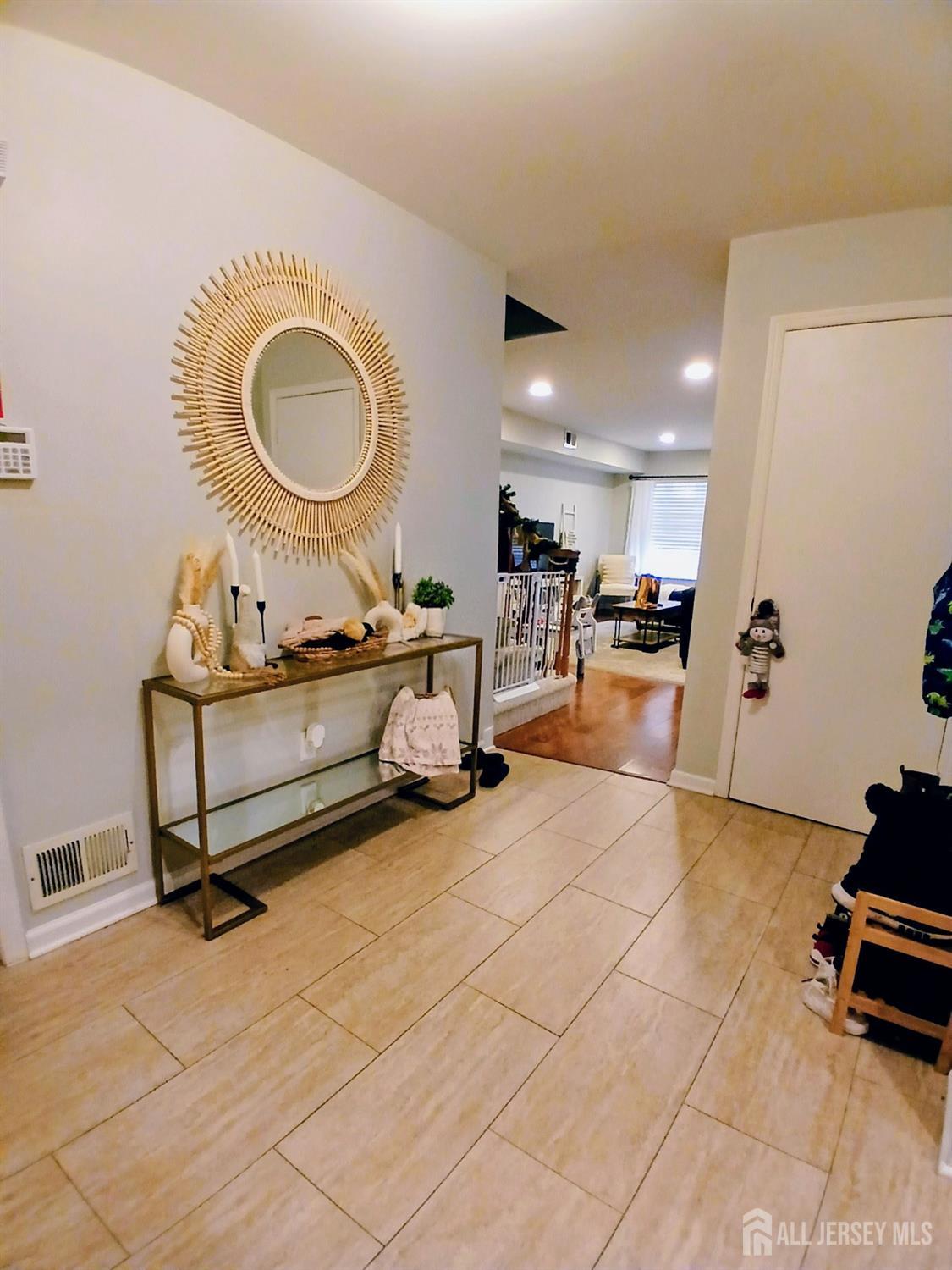 119 Nightingale Court Old Bridge, NJ 08857 - Photo 3 of 18 a living room with furniture a mirror and a view of kitchen