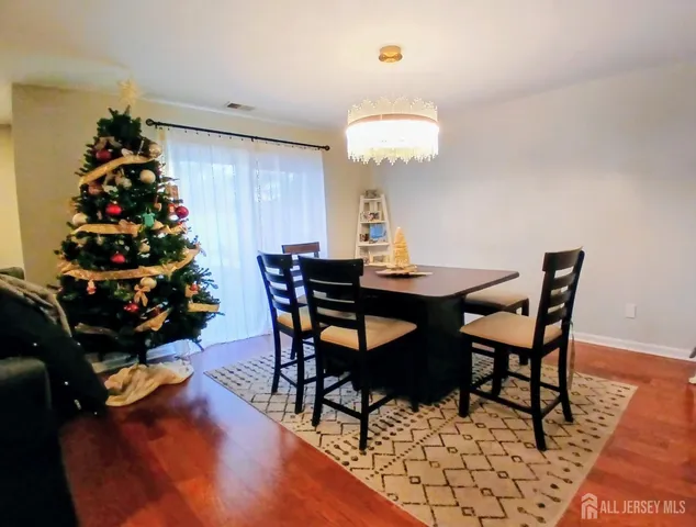 a view of a dining room with furniture and chandelier