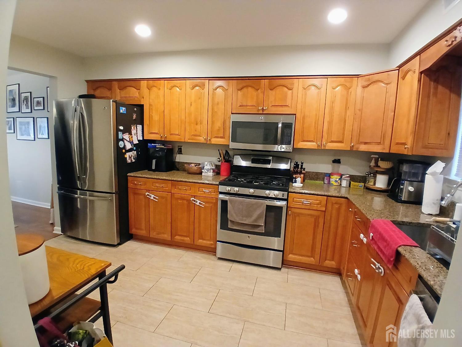 119 Nightingale Court Old Bridge, NJ 08857 - Photo 6 of 18 a kitchen with stainless steel appliances a stove a sink refrigerator and a microwave