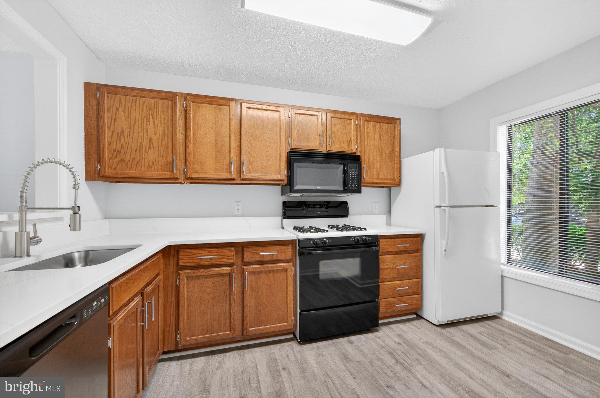 2281 Hunter's Run Drive, Unit 2281 Reston, VA 20191 - Photo 5 of 25 Modern kitchen with warm wood accents.