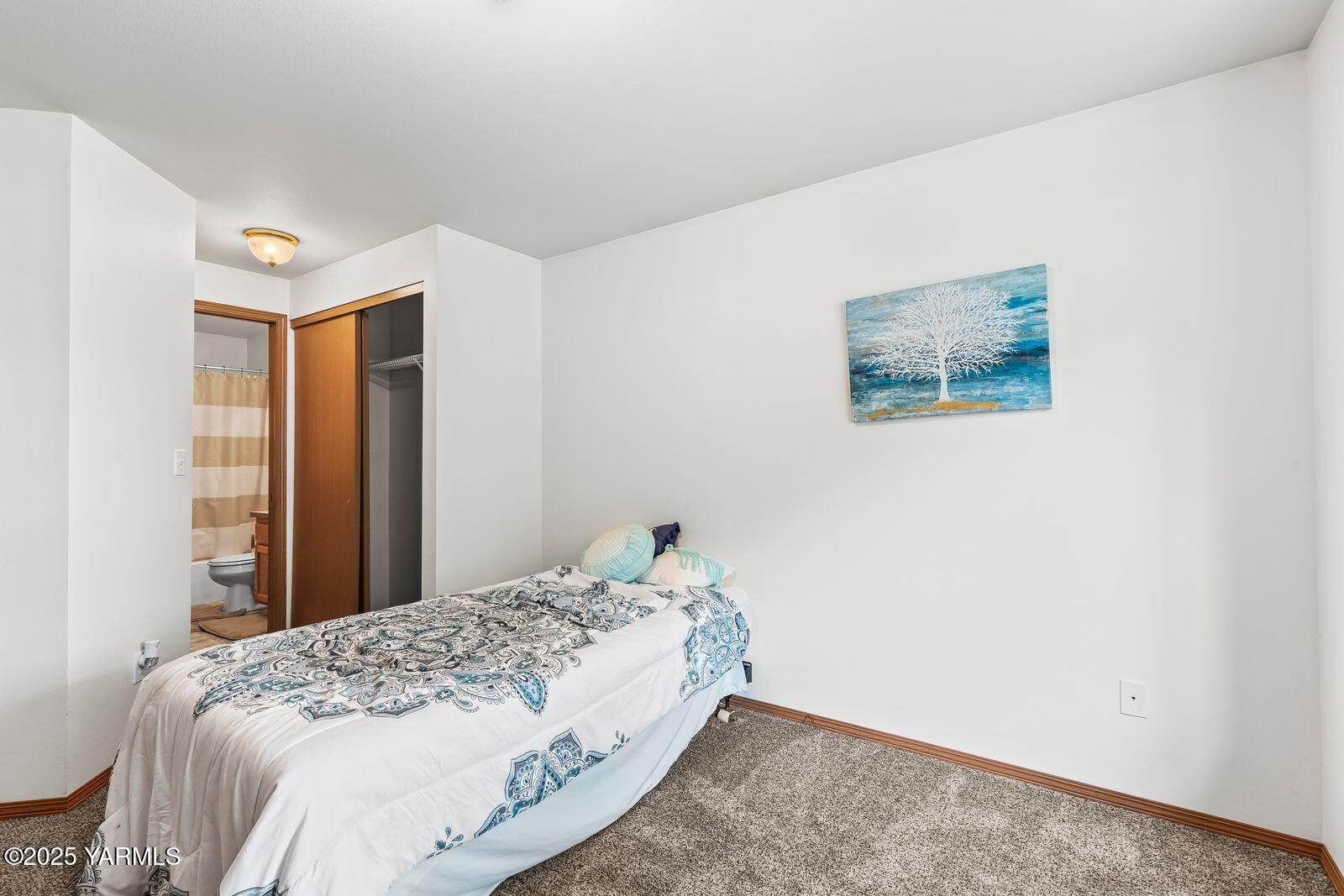 105 Peach Tree Lane, Unit 3 Yakima, WA 98908 - Photo 12 of 21 a bedroom with a bed and a painting on the wall