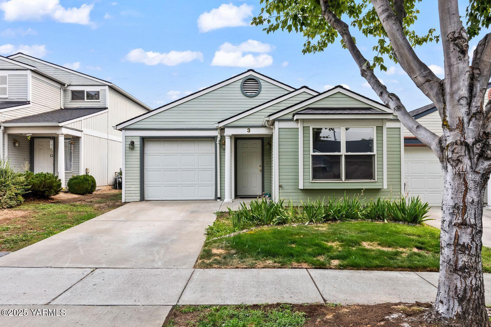 105 Peach Tree Lane, Unit 3 Yakima, WA 98908 - Photo 2 of 21 a front view of a house with a yard