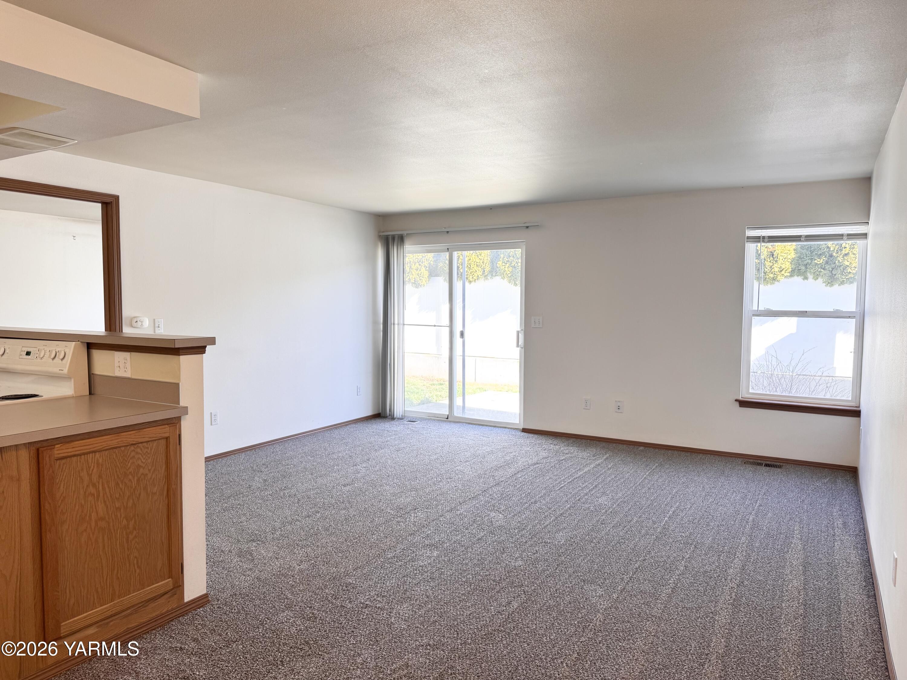 105 Peach Tree Lane, Unit 3 Yakima, WA 98908 - Photo 6 of 21 a view of empty room with wooden floor and fan