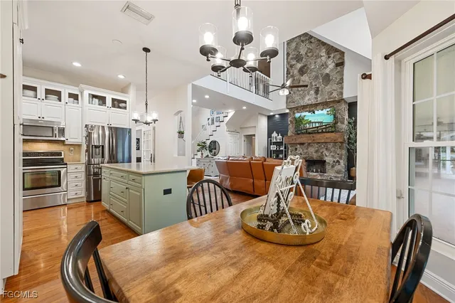 a very nice looking dining room with kitchen island furniture a chandelier