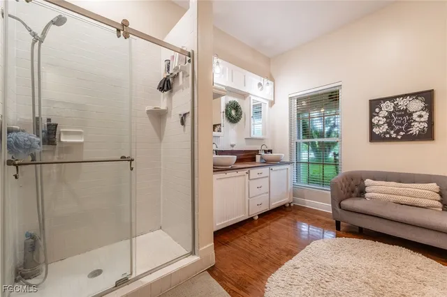 a bathroom with a tub shower and mirror