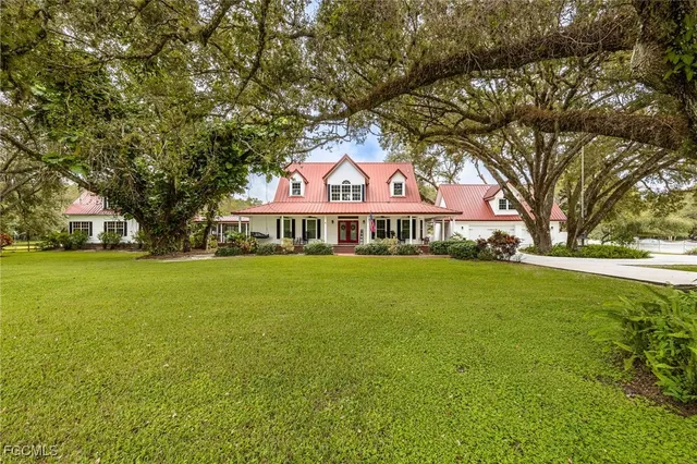 a front view of house with yard and green space