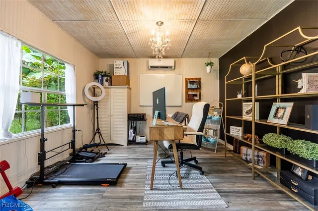 a view of a workspace with furniture window and wooden floor