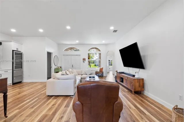 a view of a dining room with furniture and wooden floor