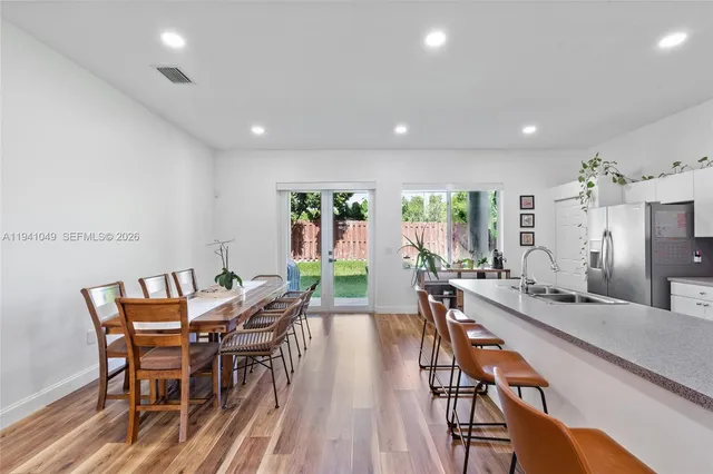 a dining room with furniture and wooden floor