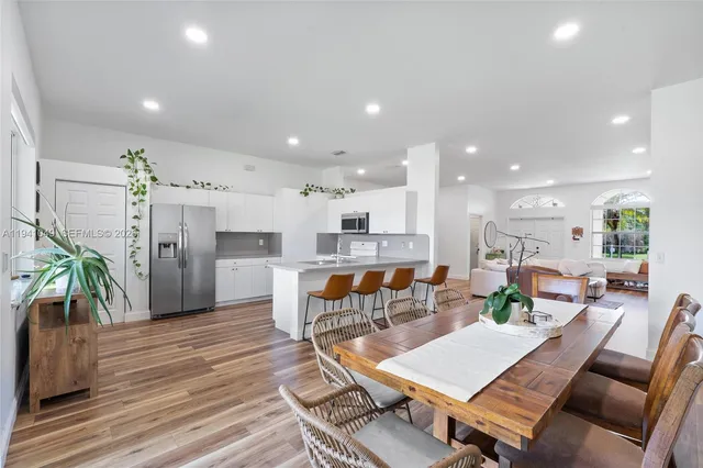 a kitchen with stainless steel appliances a refrigerator sink and microwave