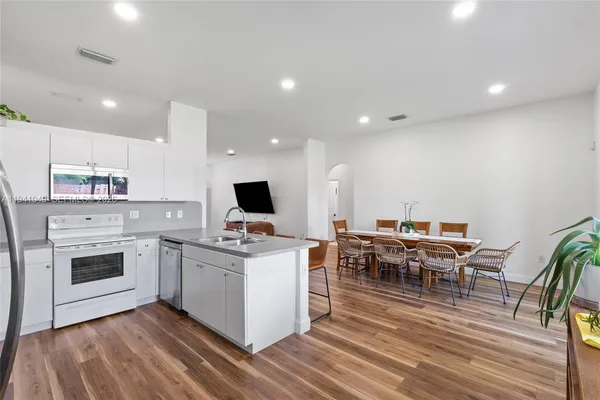 a kitchen with a sink a table and chairs