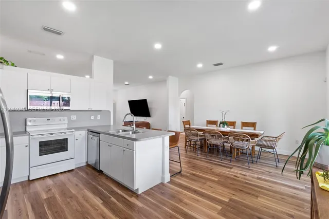 a kitchen with a sink a table and chairs
